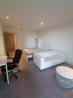 A simple and clean bedroom featuring a white si...