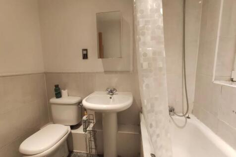 A clean and functional bathroom featuring a whi...