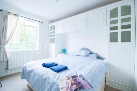 Bright and airy master bedroom featuring a larg...