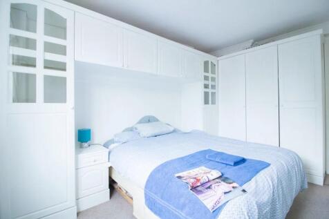 Bright and neatly arranged double bedroom featu...