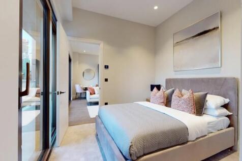 A stylish and spacious master bedroom featuring...