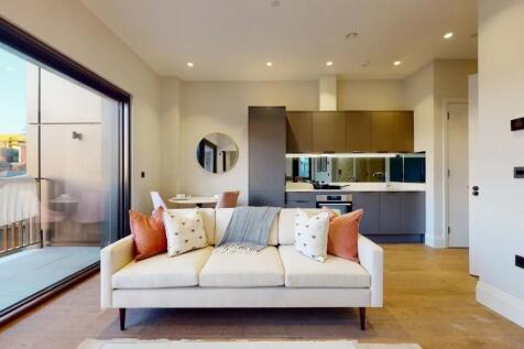 A modern living room featuring a stylish cream ...