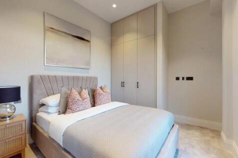 A stylish double bedroom featuring a comfortabl...