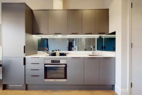 A sleek, modern kitchen with minimalist grey ca...