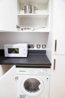 Compact and well-maintained kitchen area featur...