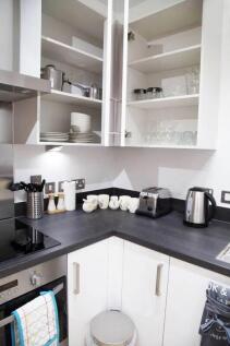 Bright and modern kitchen featuring a sleek bla...