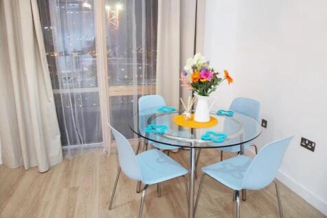 Bright and modern dining area featuring a round...
