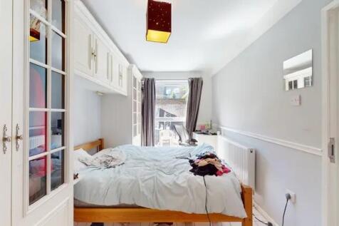 Bright double bedroom featuring a comfortable d...