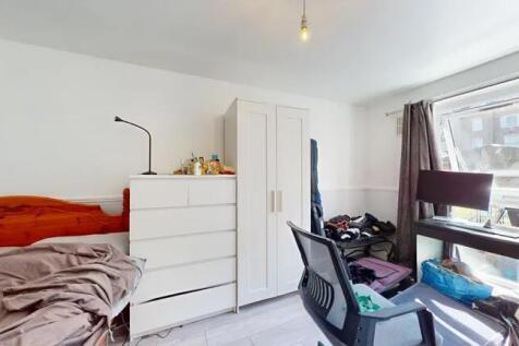 Bright single bedroom featuring a large window ...