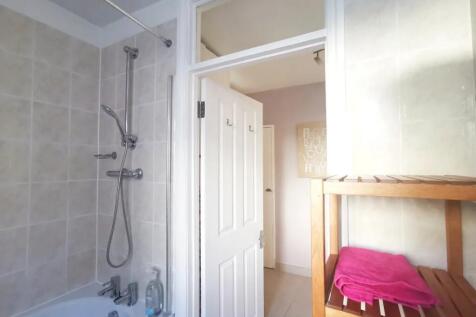 Bright and well-maintained bathroom suite featu...