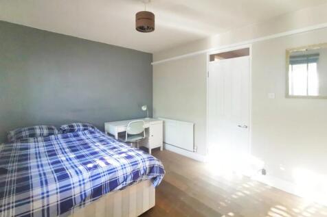 A bright and tidy double bedroom featuring a co...