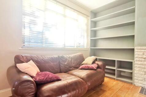 A cozy living room featuring a comfortable brow...