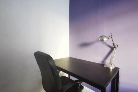 A neat and modern workspace featuring a sleek b...