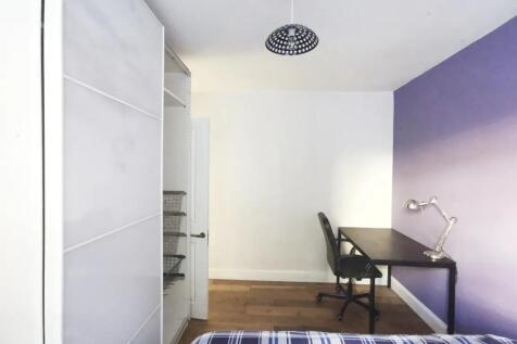 Bright and tidy bedroom featuring a comfortable...
