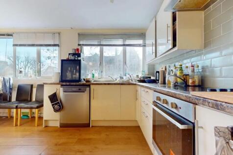 Bright and airy kitchen featuring large windows...