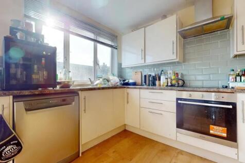 Bright and modern kitchen featuring ample cabin...
