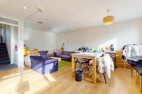 Bright living room with large windows allowing ...