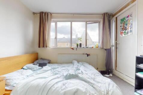 A cozy double bedroom featuring a large window ...