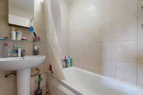 A clean and functional bathroom suite featuring...