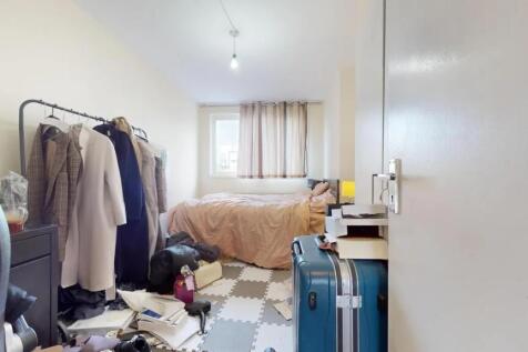 A compact double bedroom featuring a comfortabl...