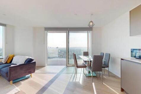 Bright and modern living room featuring a styli...
