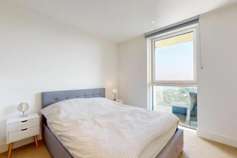 Bright and modern master bedroom featuring a co...