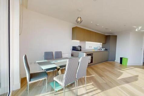 Bright and modern kitchen featuring sleek cabin...