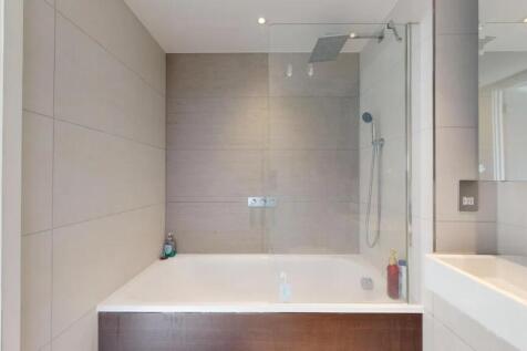 A modern bathroom suite featuring a large batht...