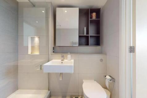 A modern, immaculately clean bathroom featuring...