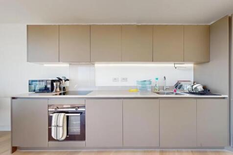 A modern and sleek kitchen featuring clean line...