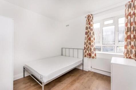 A bright, clean double bedroom featuring a meta...