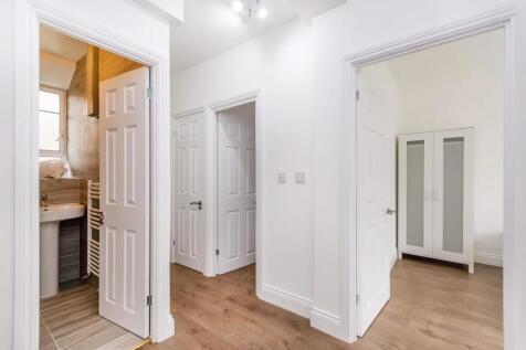 A bright and clean hallway with white walls and...