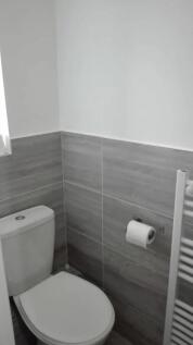 A clean and modern single toilet featuring neut...