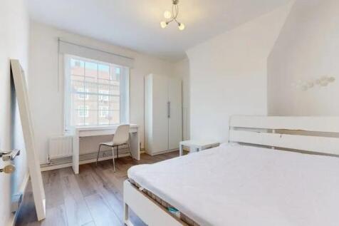 Bright and airy master bedroom featuring a larg...