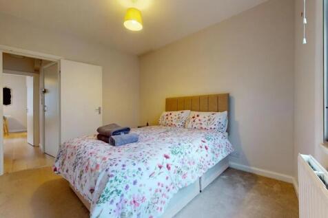 A cozy double bedroom featuring a comfortable d...