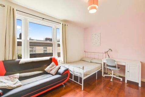 Bright and welcoming double bedroom featuring a...
