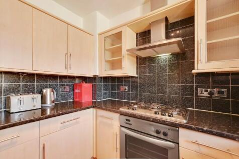 Bright and tidy kitchen featuring modern applia...