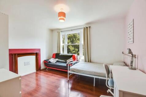 A bright and inviting single bedroom featuring ...