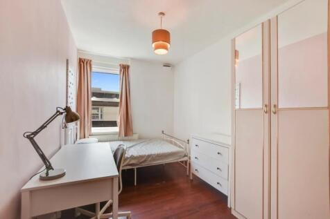 A neat and bright single bedroom featuring a wh...