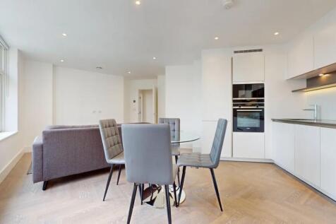 Bright and modern living room with a sleek kitc...