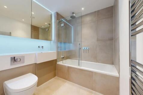 A sleek and modern bathroom suite featuring a f...