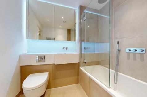 A modern and spotless bathroom suite featuring ...