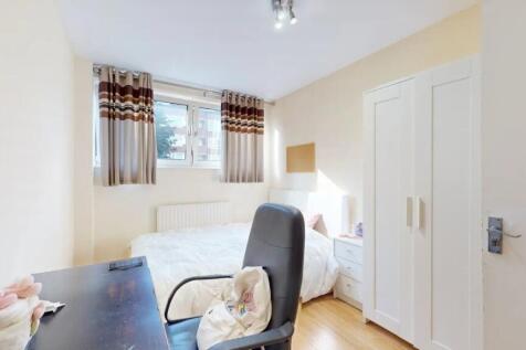 A bright and inviting master bedroom featuring ...