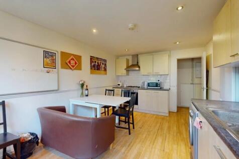 Bright and tidy kitchen featuring modern applia...