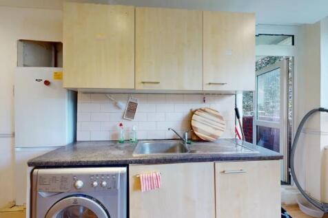 Bright kitchen featuring light wood cabinets, a...