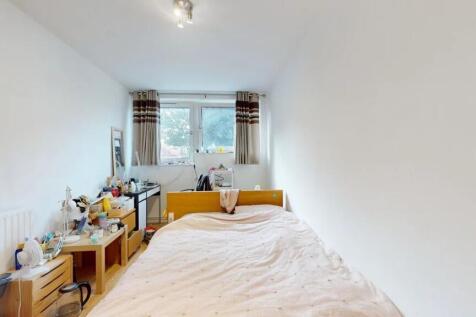A cozy double bedroom featuring a large window ...