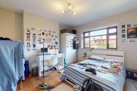 Bright and spacious bedroom featuring a large w...