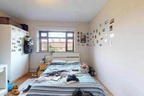 Bright double bedroom featuring a large window ...