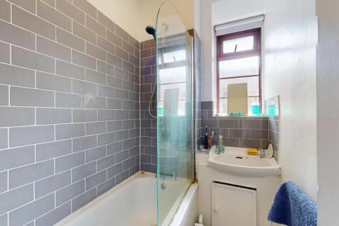A neat and functional bathroom featuring modern...