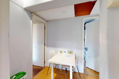 A simple communal workspace featuring a white t...